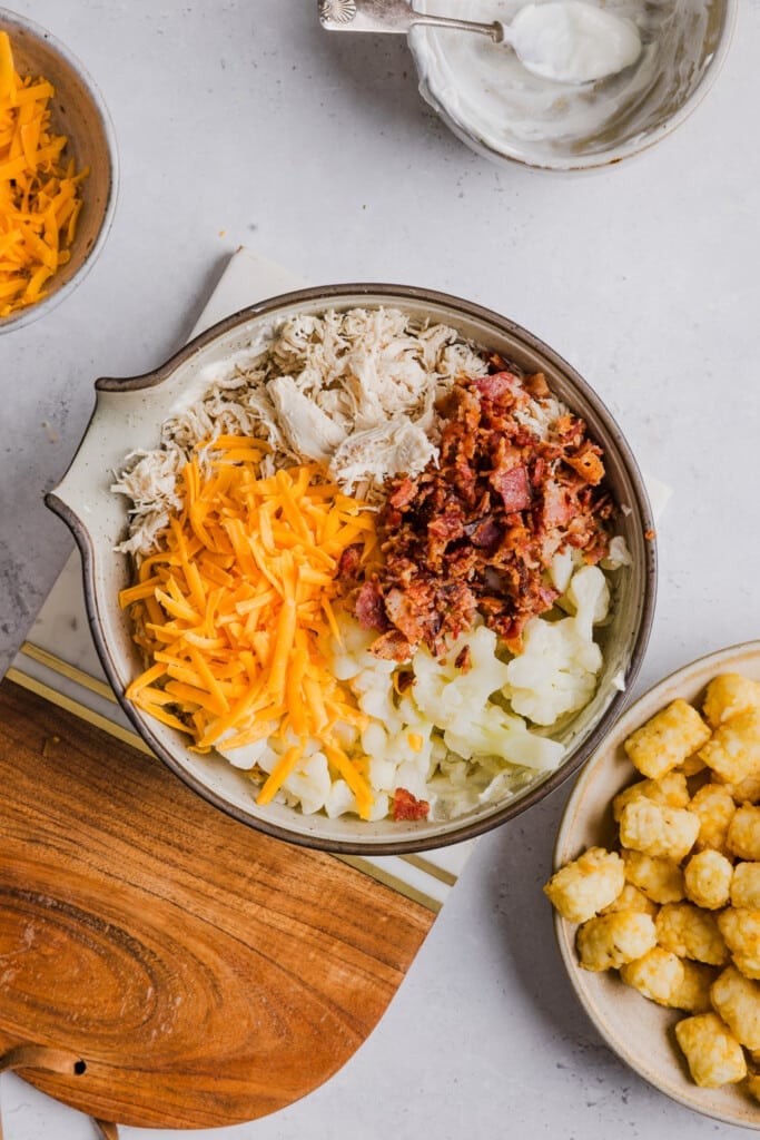 Chicken bacon ranch tater tot casserole ingredients in a bowl.