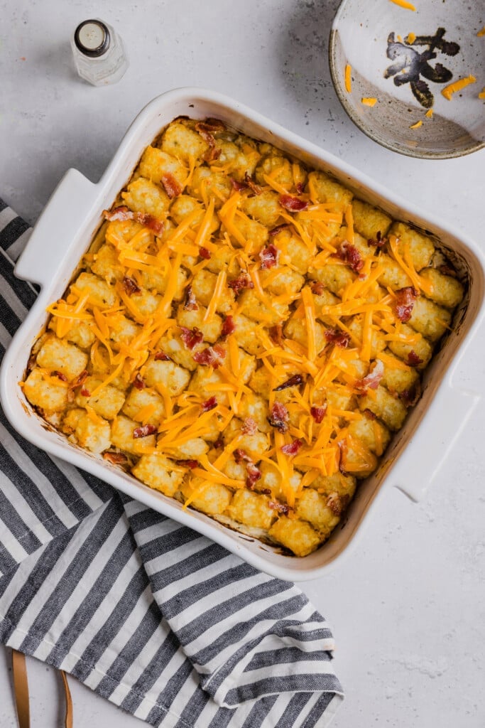 Toppings added to a chicken bacon ranch tater tot casserole after being baked.