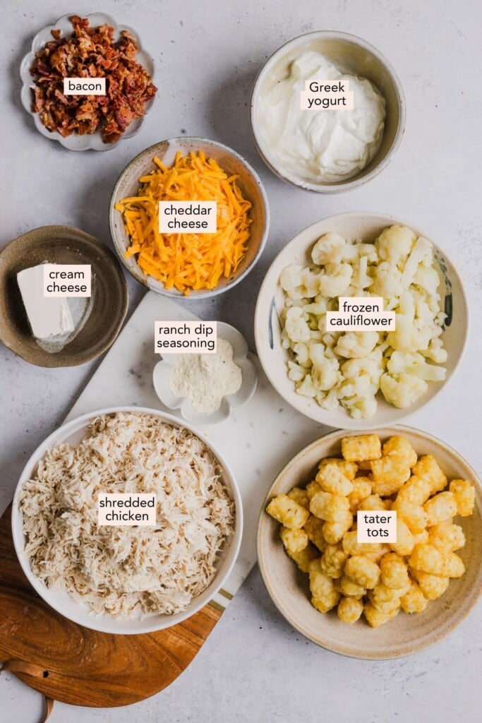 Ingredients for chicken bacon ranch tater tot casserole on a countertop with labels.