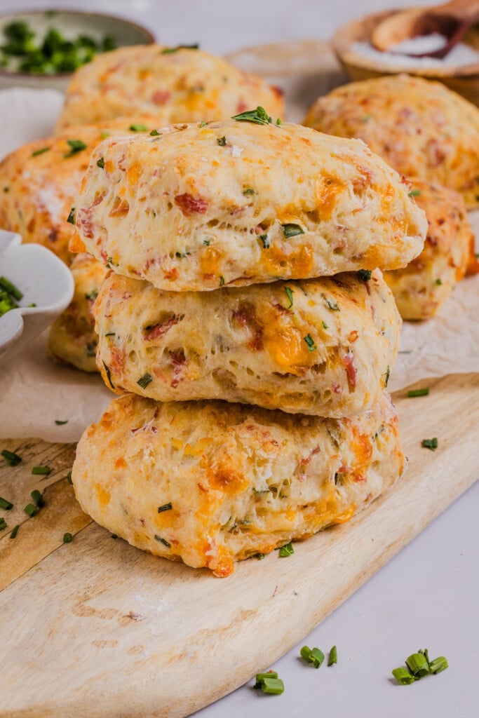 High protein biscuits stacked on a wooden board.