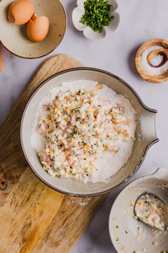 Wet ingredients being mixed with dry ingredients to form high protein breakfast biscuit dough.