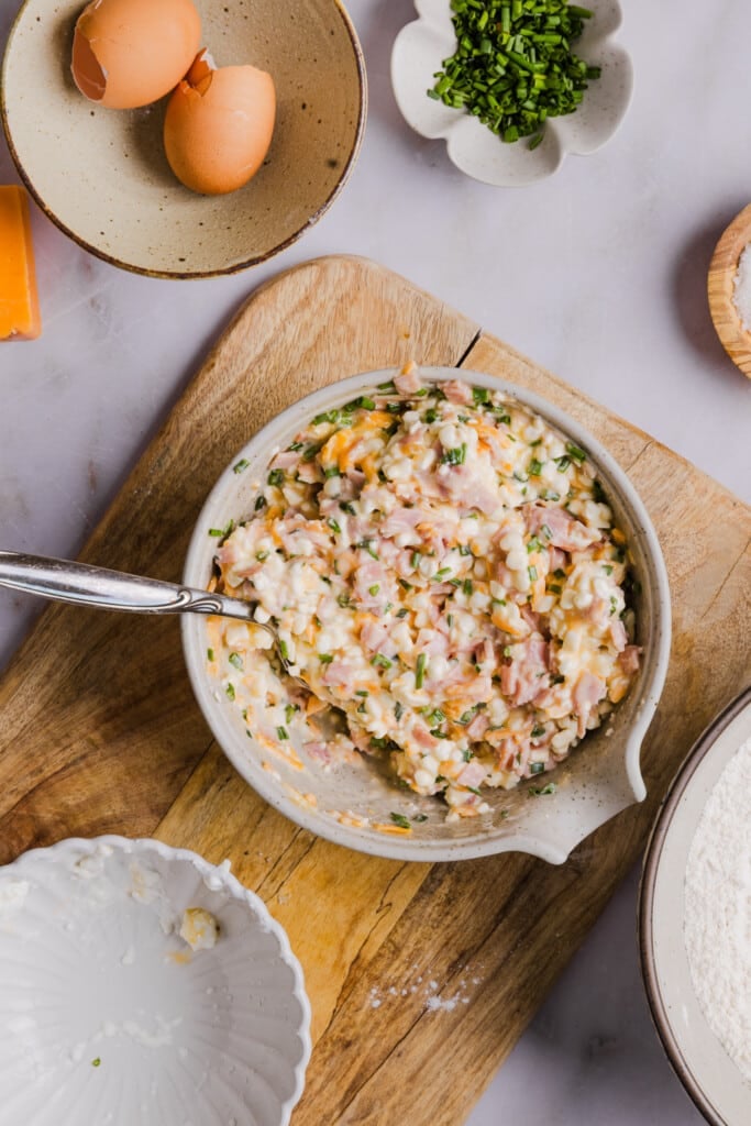 Wet ingredients for protein biscuits mixed up in a bowl with a spoon.
