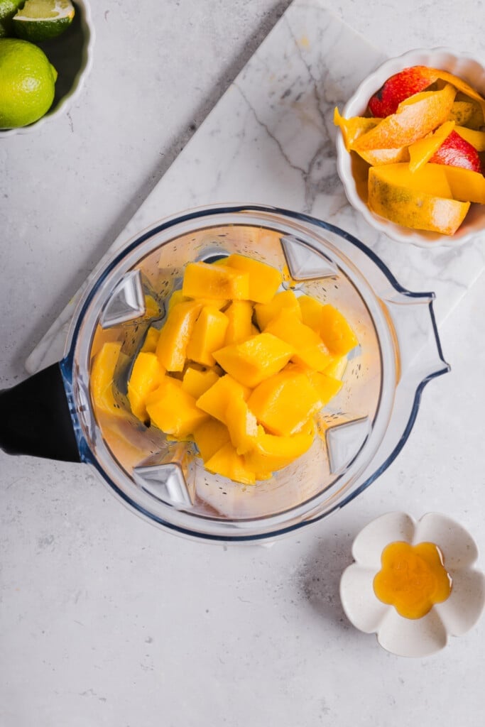 Mango sorbet ingredients are added to a Ninja Creami.