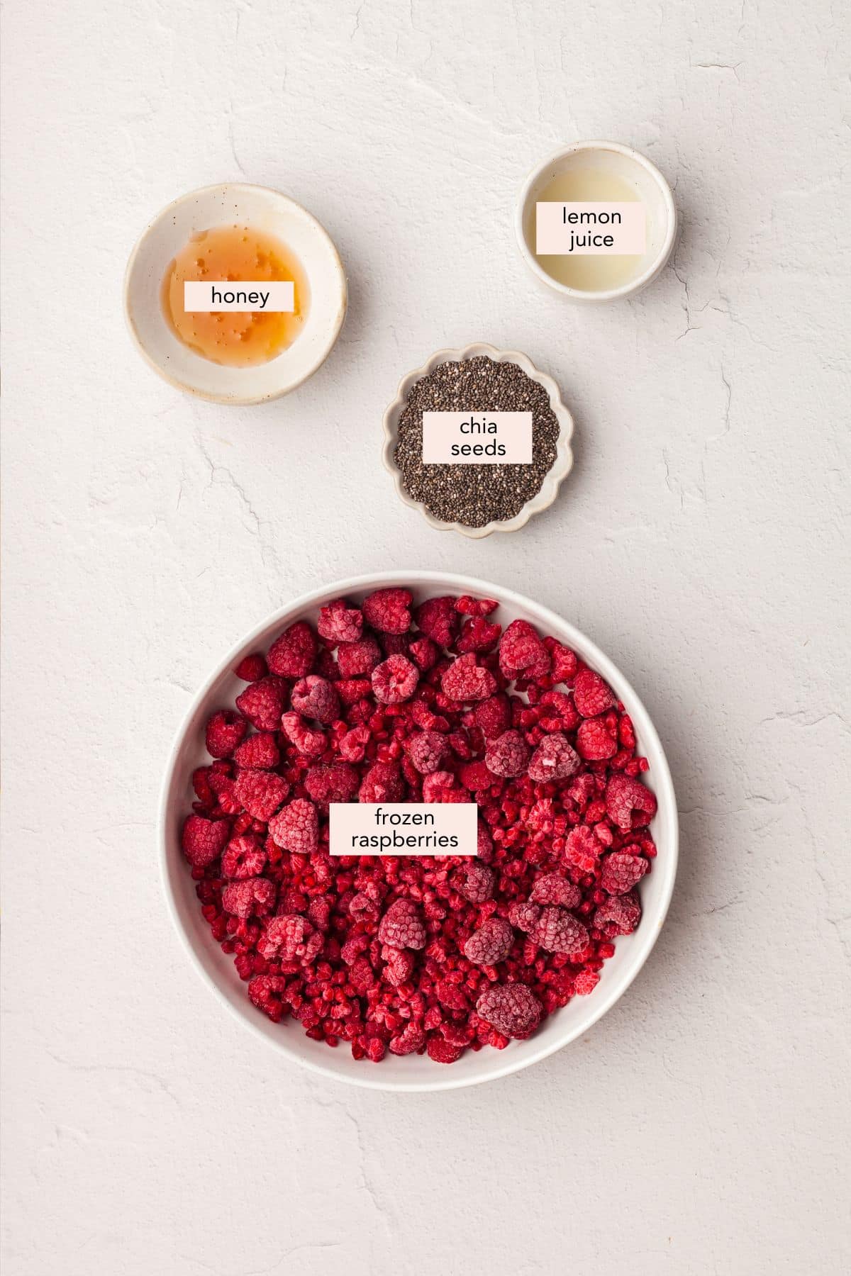 Labeled ingredients for raspberry chia jam.