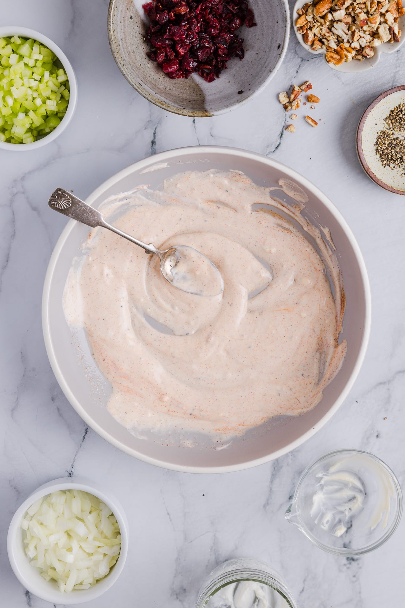 Ingredients for Cape Cod chicken salad dressing mixed in a large bowl.
