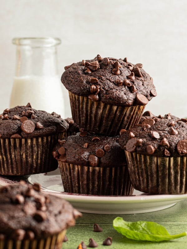Chocolate veggie muffins stacked on a plate.