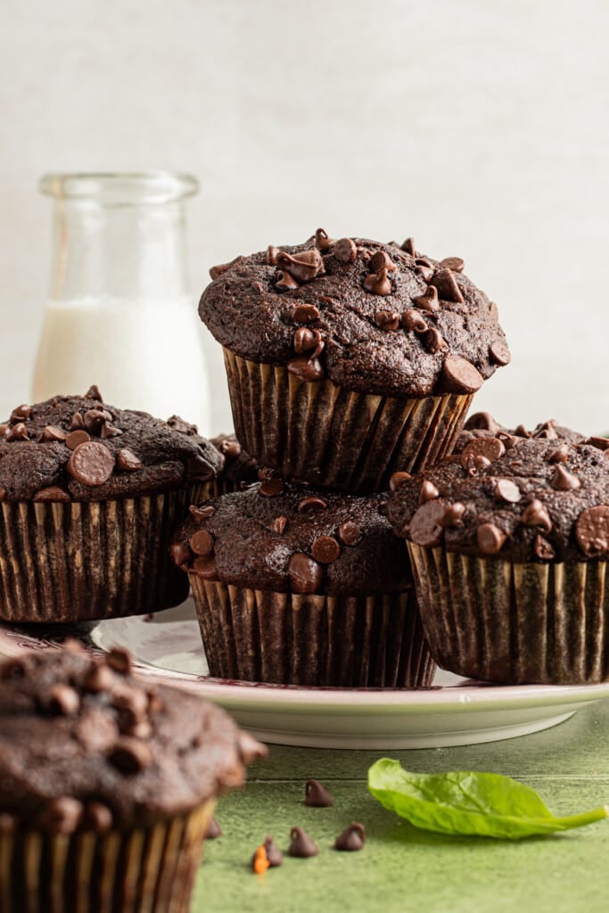 Chocolate veggie muffins stacked on a plate.
