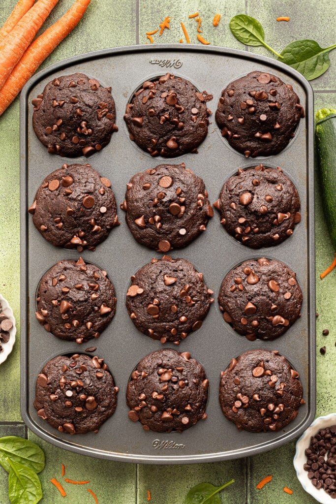 Chocolate veggie muffins baked in a muffin pan.