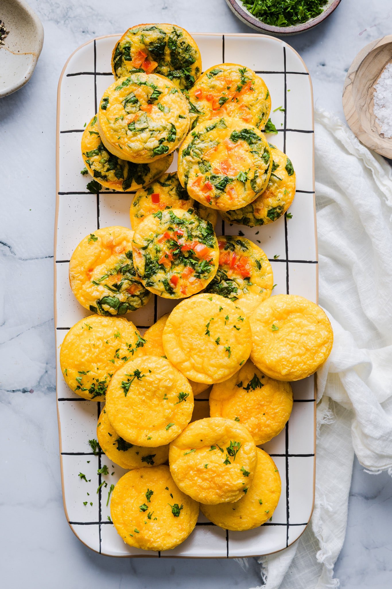 A platter with a mix of plain and veggie cottage cheese egg bites.