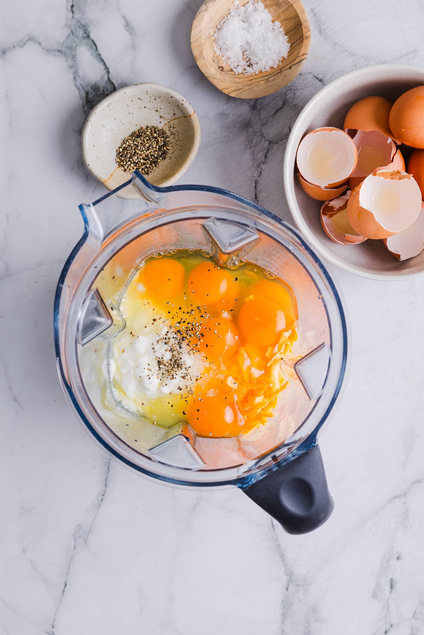 Cottage cheese, cheese, eggs, salt and pepper in a blender.