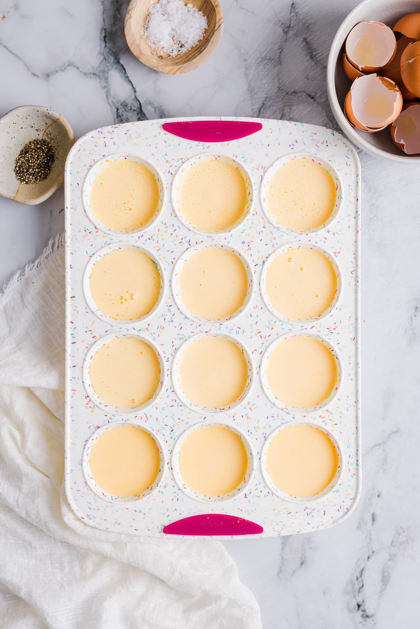 Cottage cheese egg bite mixture added to a silicone muffin pan.