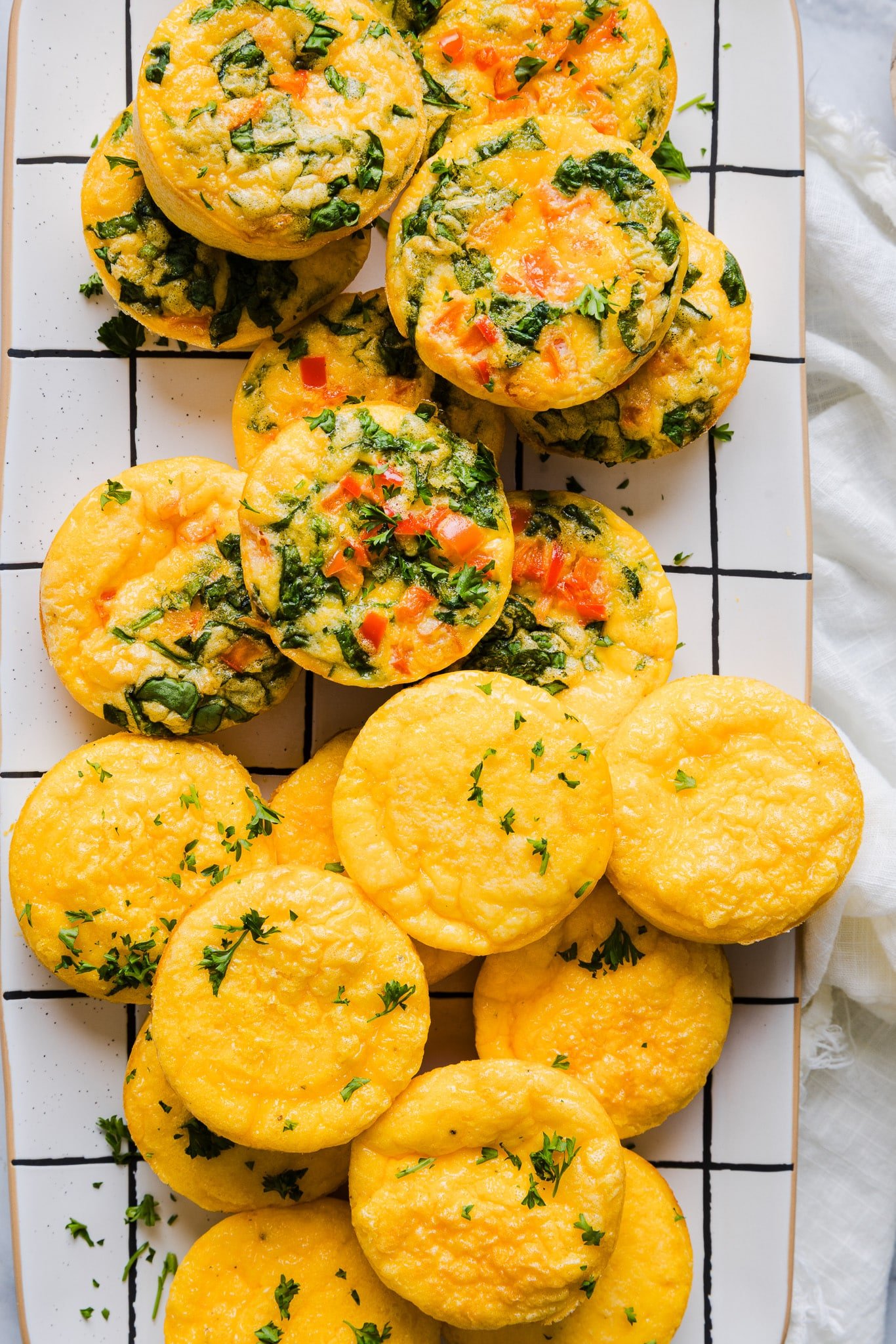 A platter with a mix of plain and veggie cottage cheese egg bites.