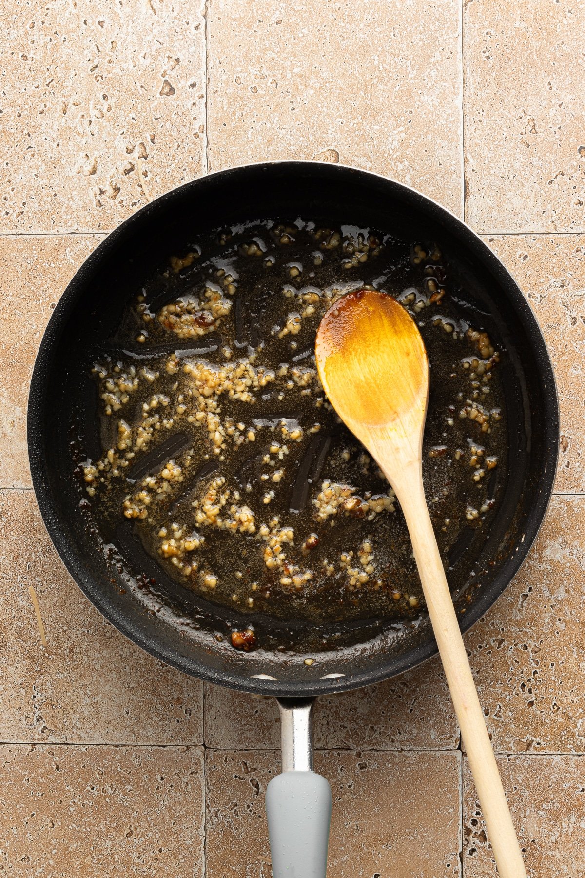 Garlic and butter sautéing in a pan.