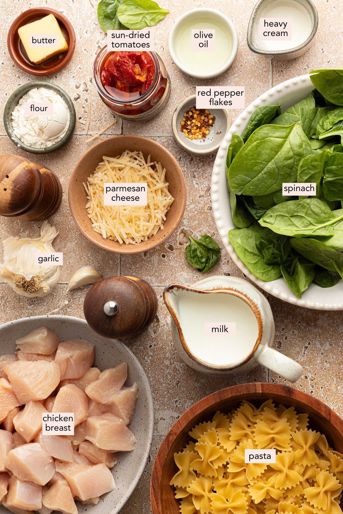 Ingredients for Marry me chicken pasta on a countertop with labels.