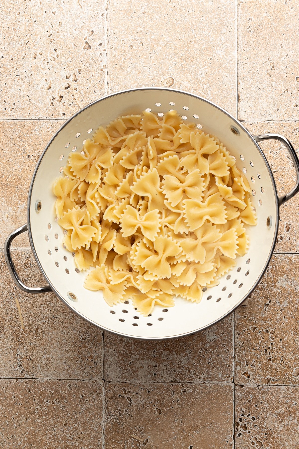 Cooked pasta in a colander.