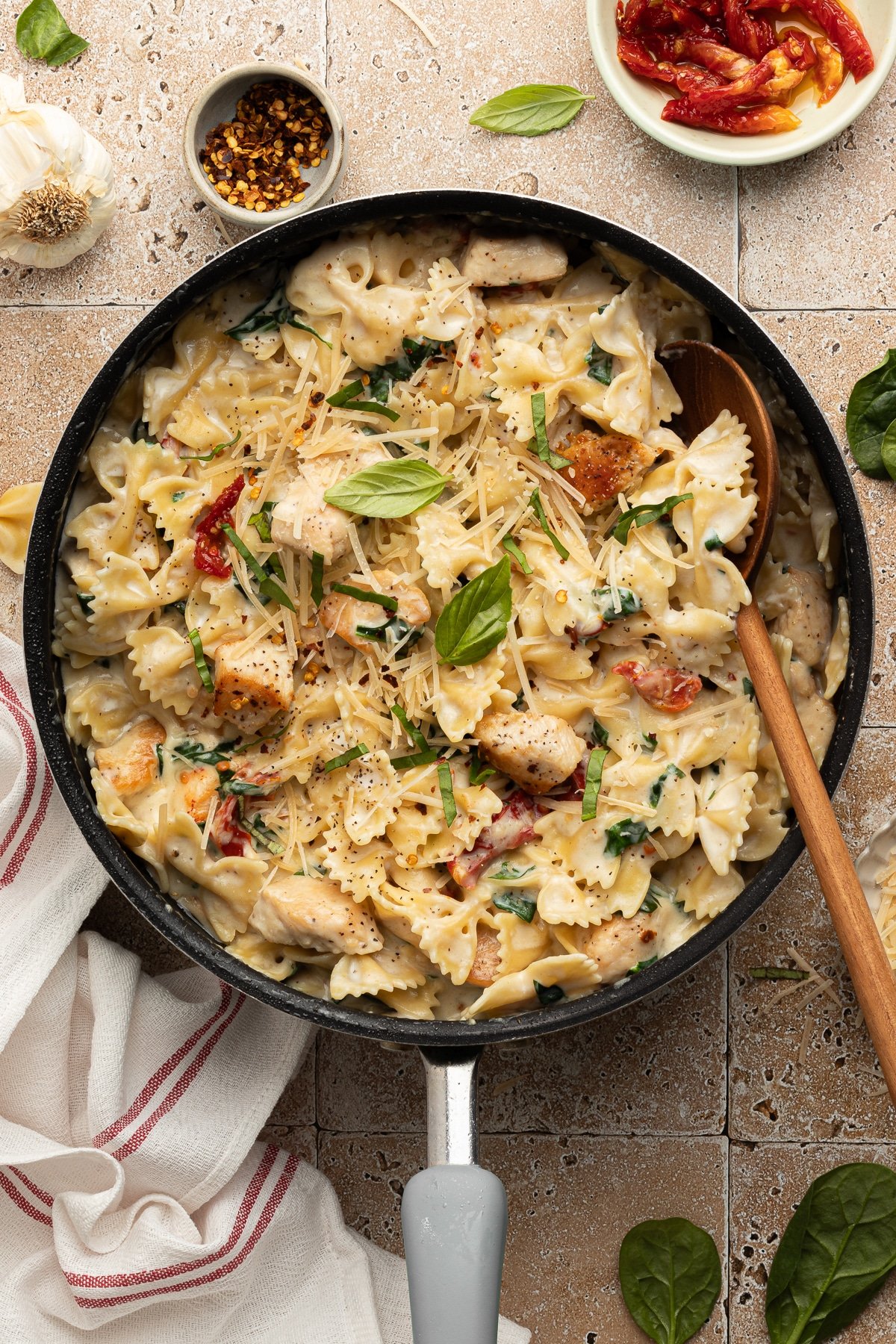 Marry me chicken pasta in a pan garnished with basil.
