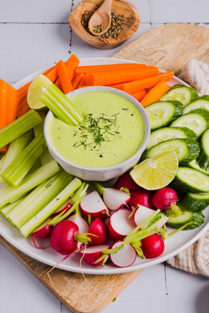 Poblano ranch dressing in a dip bowl surrounded by vegetables.