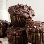 Chocolate veggie muffins stacked on a plate.