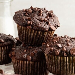 Chocolate veggie muffins stacked on a plate.