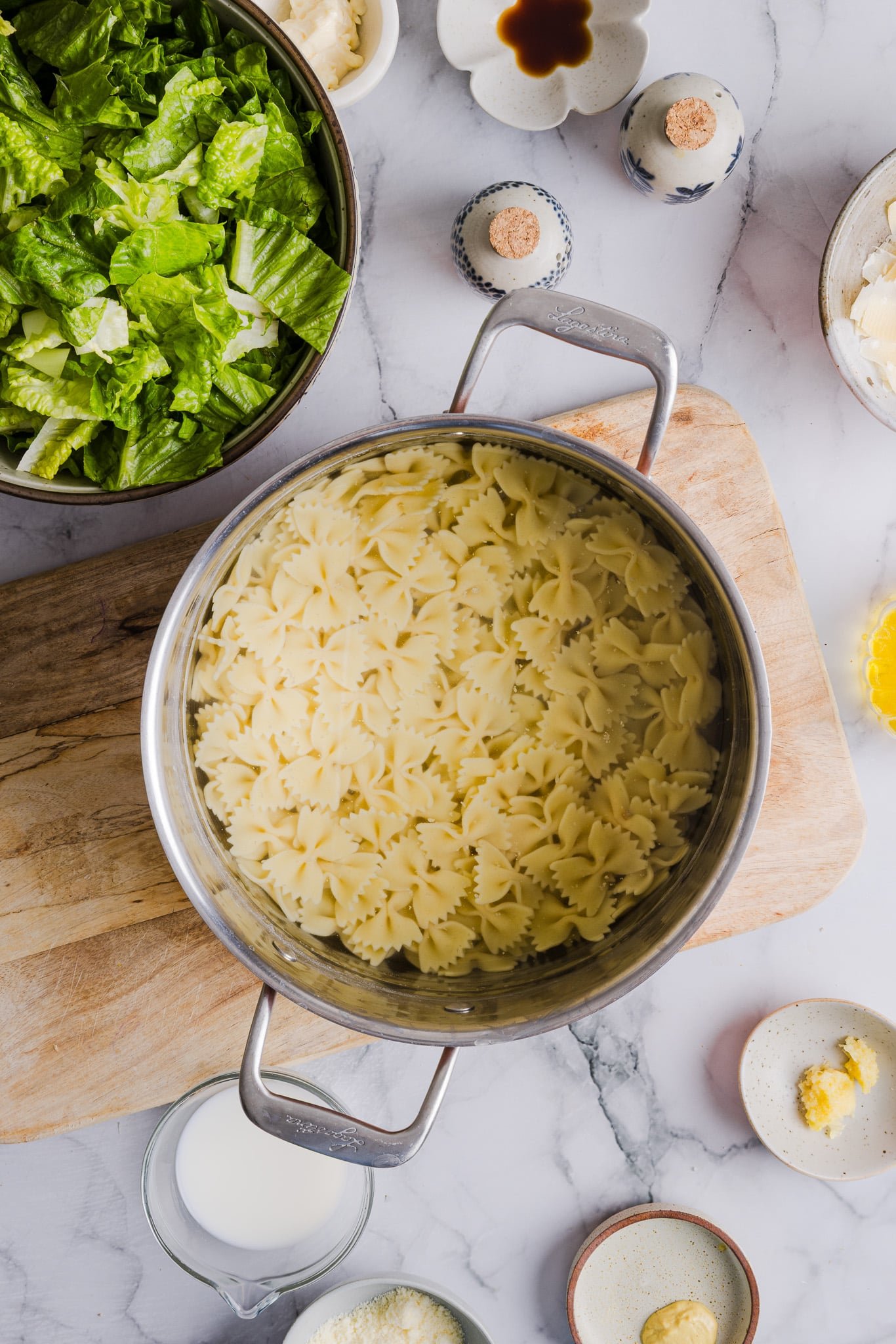 Cooked bowtie pasta in a pot.