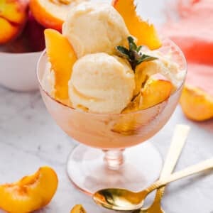 Ninja Creami peach ice cream served in a bowl with peach slices.