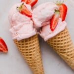 Strawberry ice cream in sugar cones.