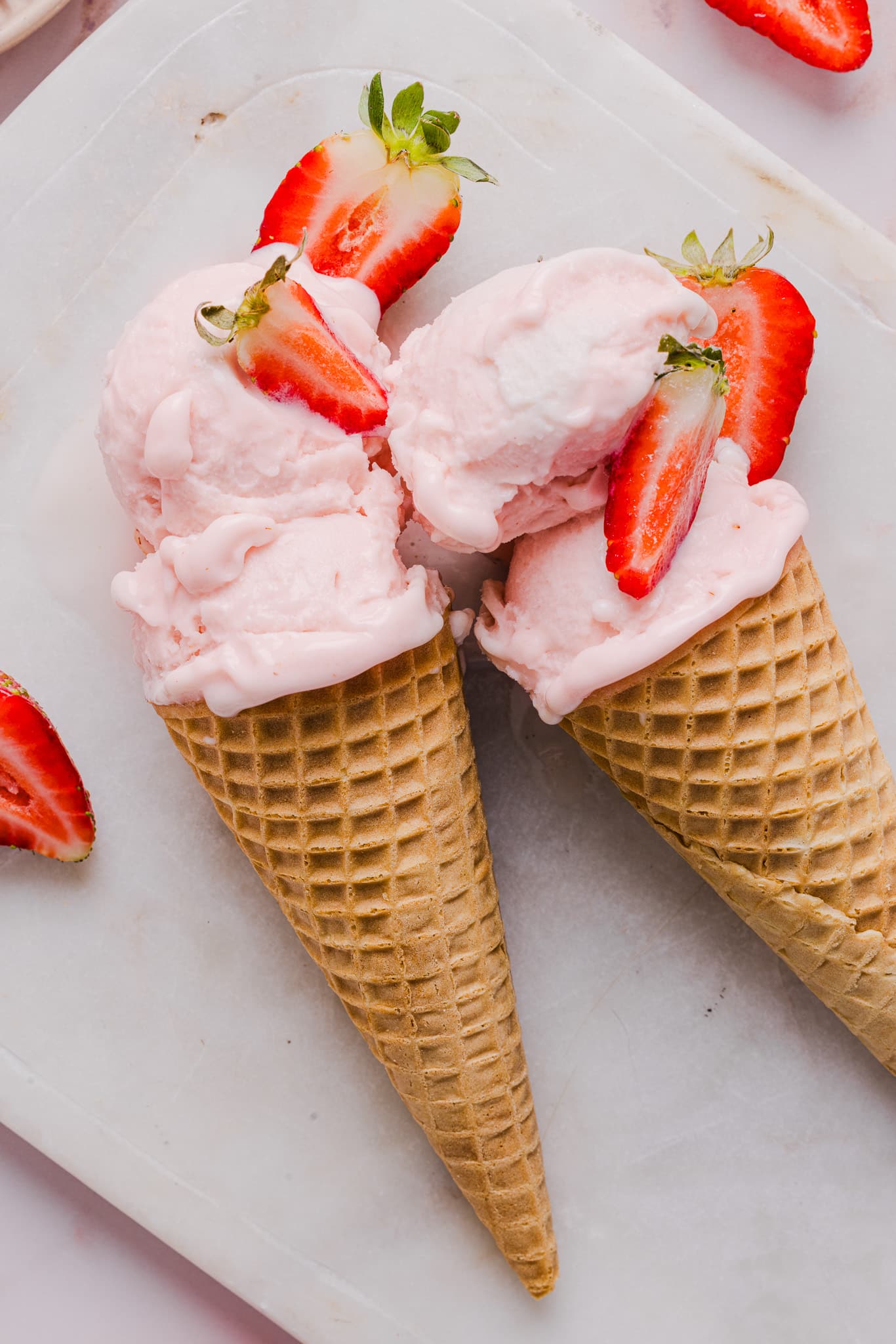 Strawberry ice cream in sugar cones.