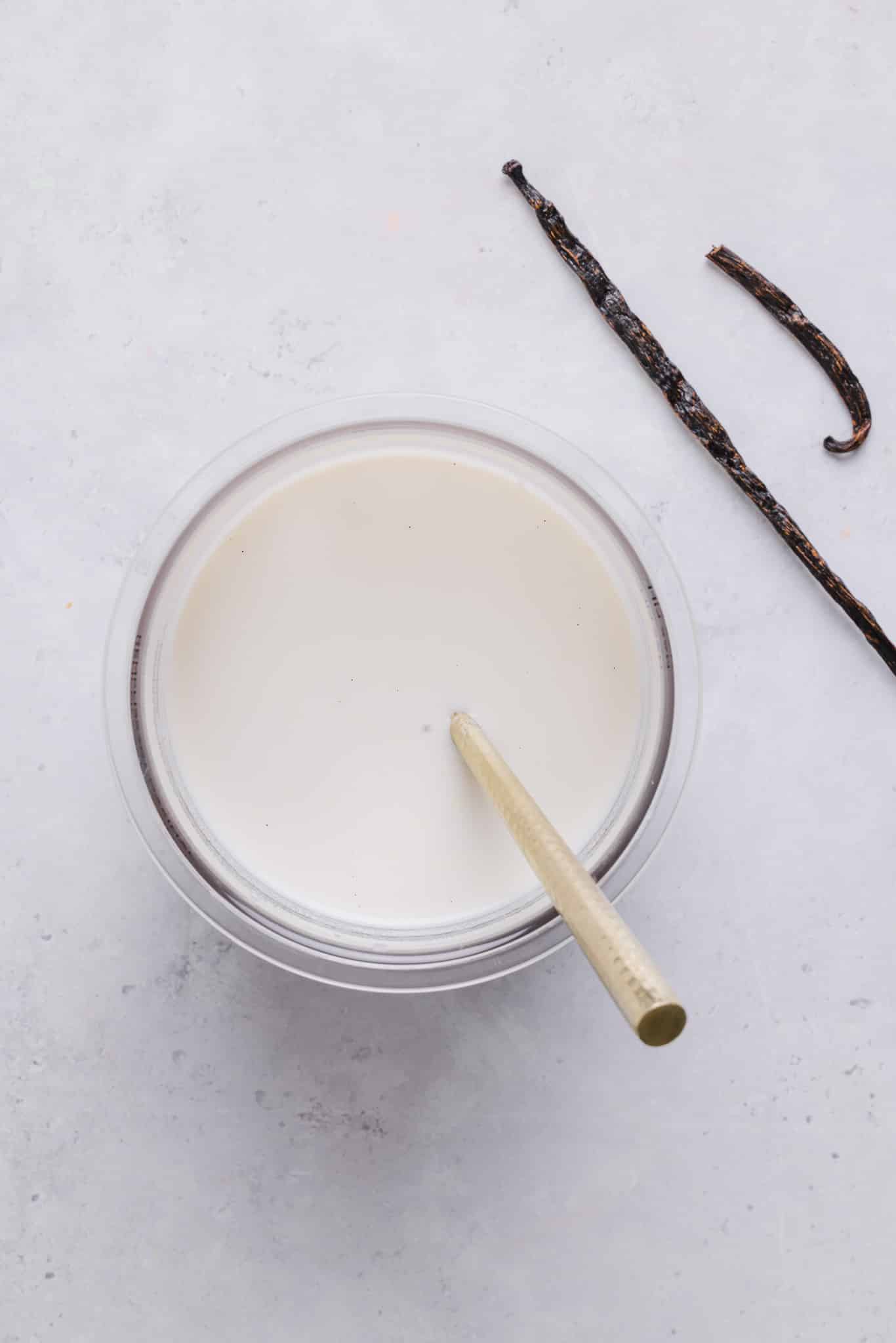 Mixing together the ingredients for vanilla ice cream in a Ninja Creami pint container.