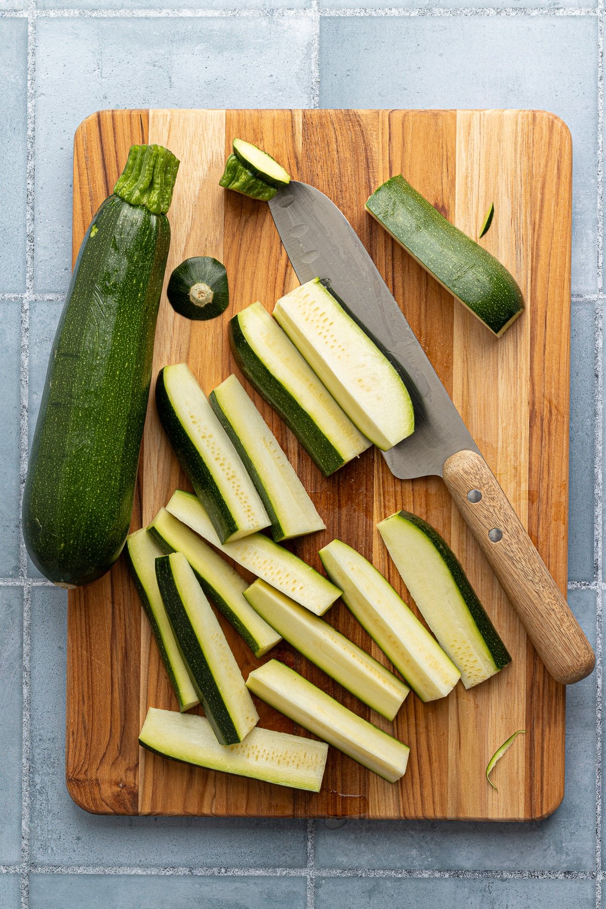 Cutting zucchini into spears to make fries.
