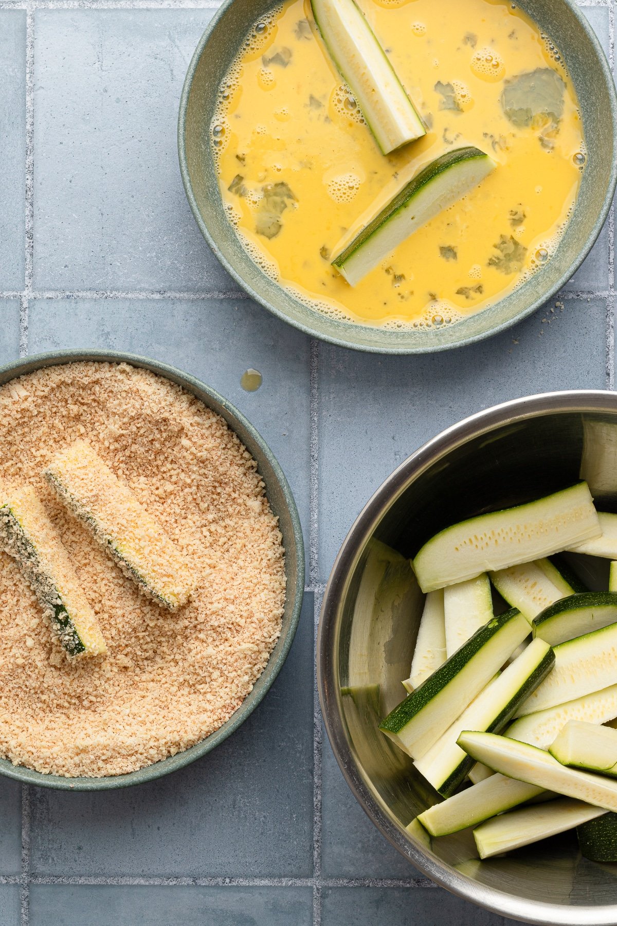 Breading zucchini spears.