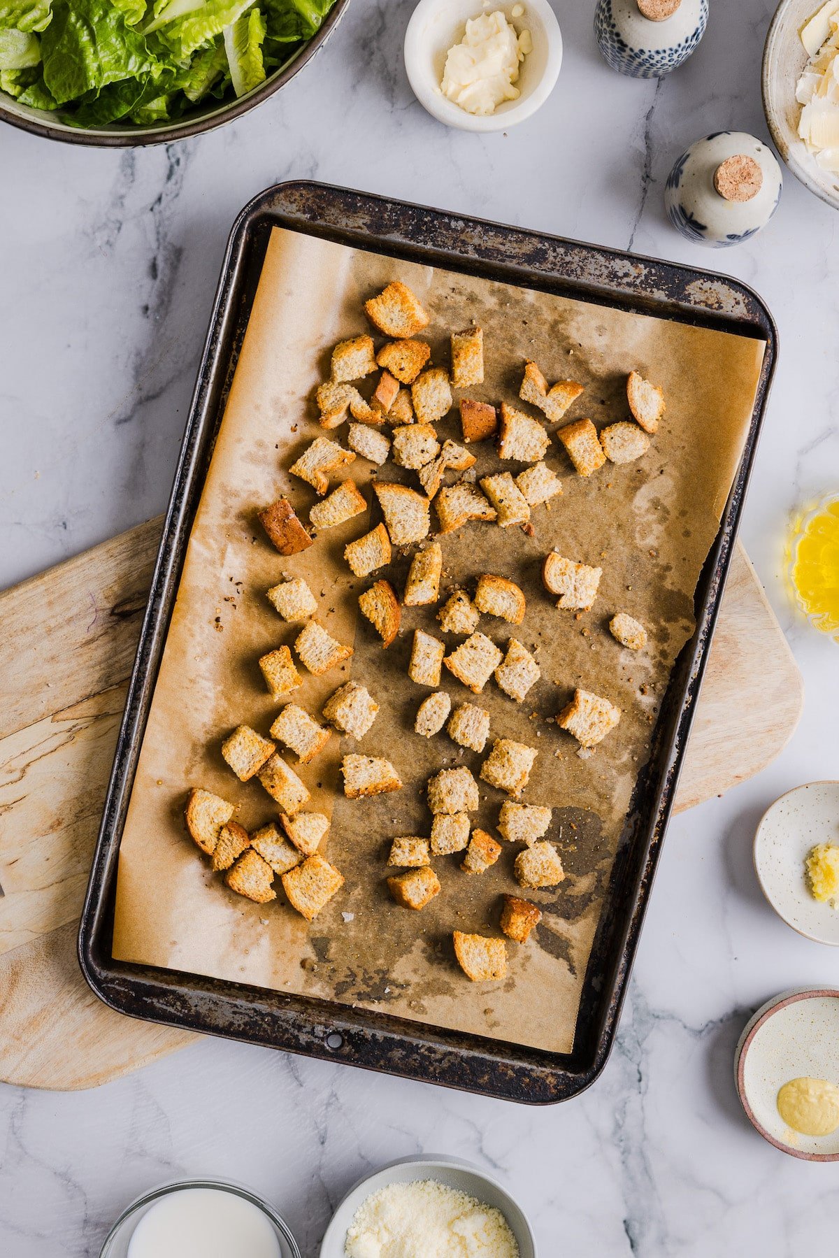 Baked croutons on a sheet pan.