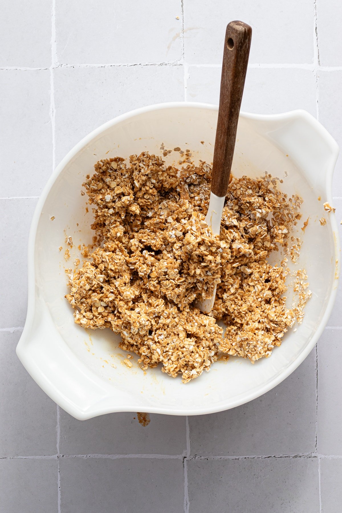 An oat mixture mixed in a bowl for no bake chocolate oat bars.