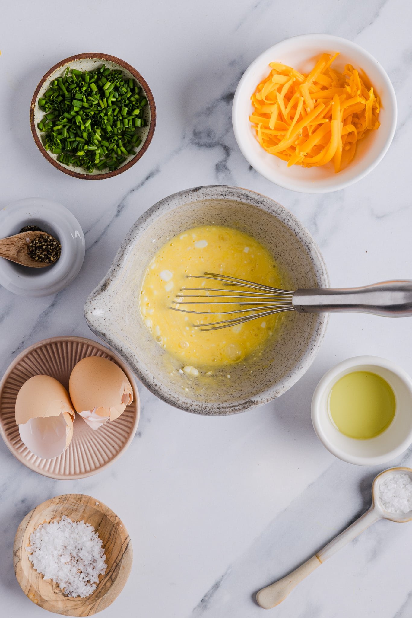 Cottage cheese and eggs whisked together in a bowl.