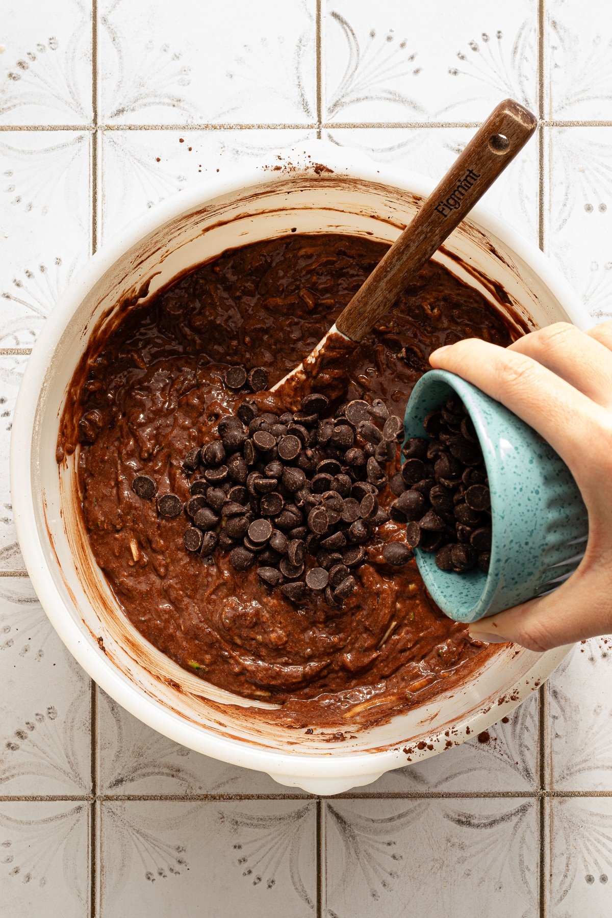 Healthy chocolate zucchini bread batter in a large bowl with chocolate chips.