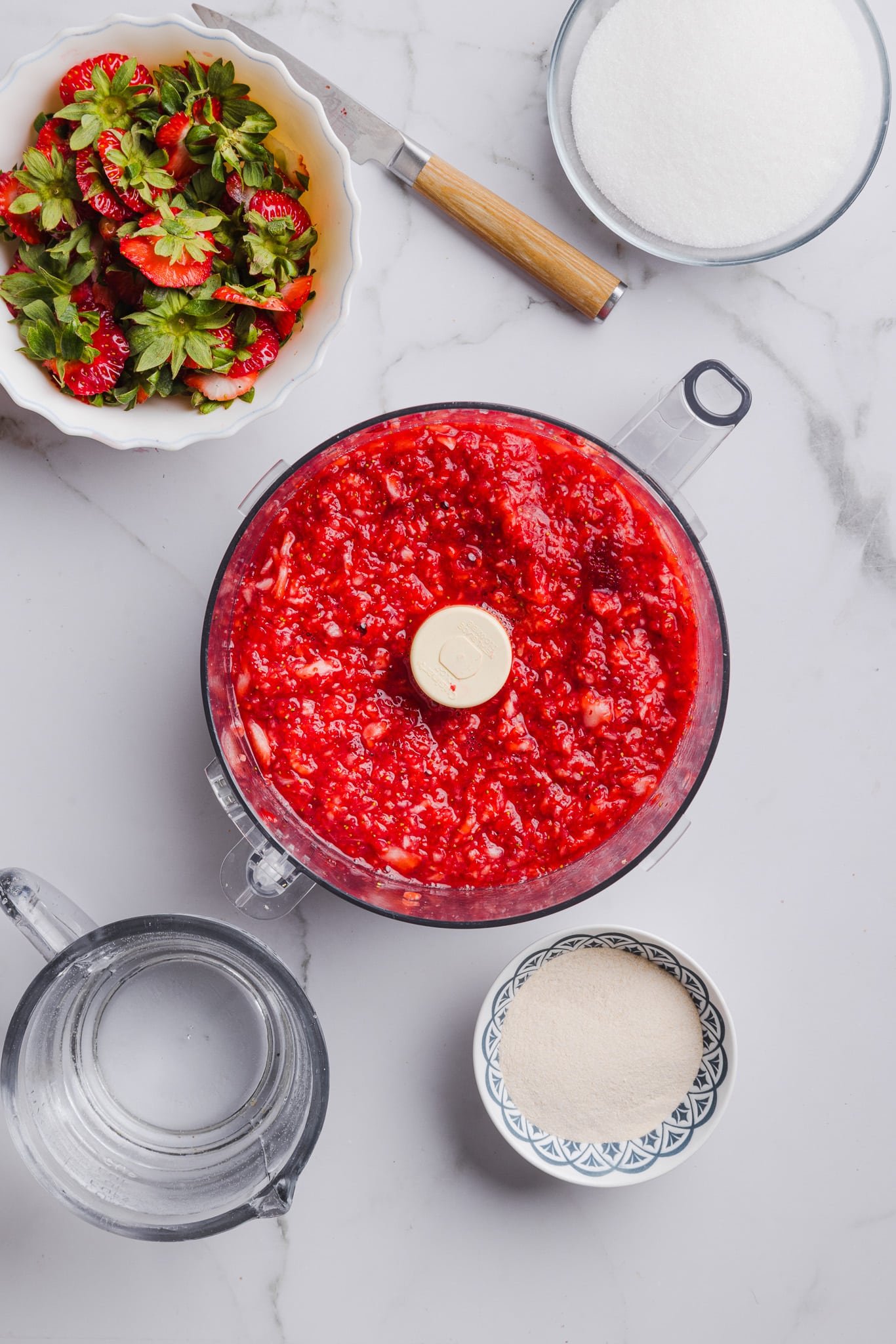 Fresh strawberries blended in a food processor.