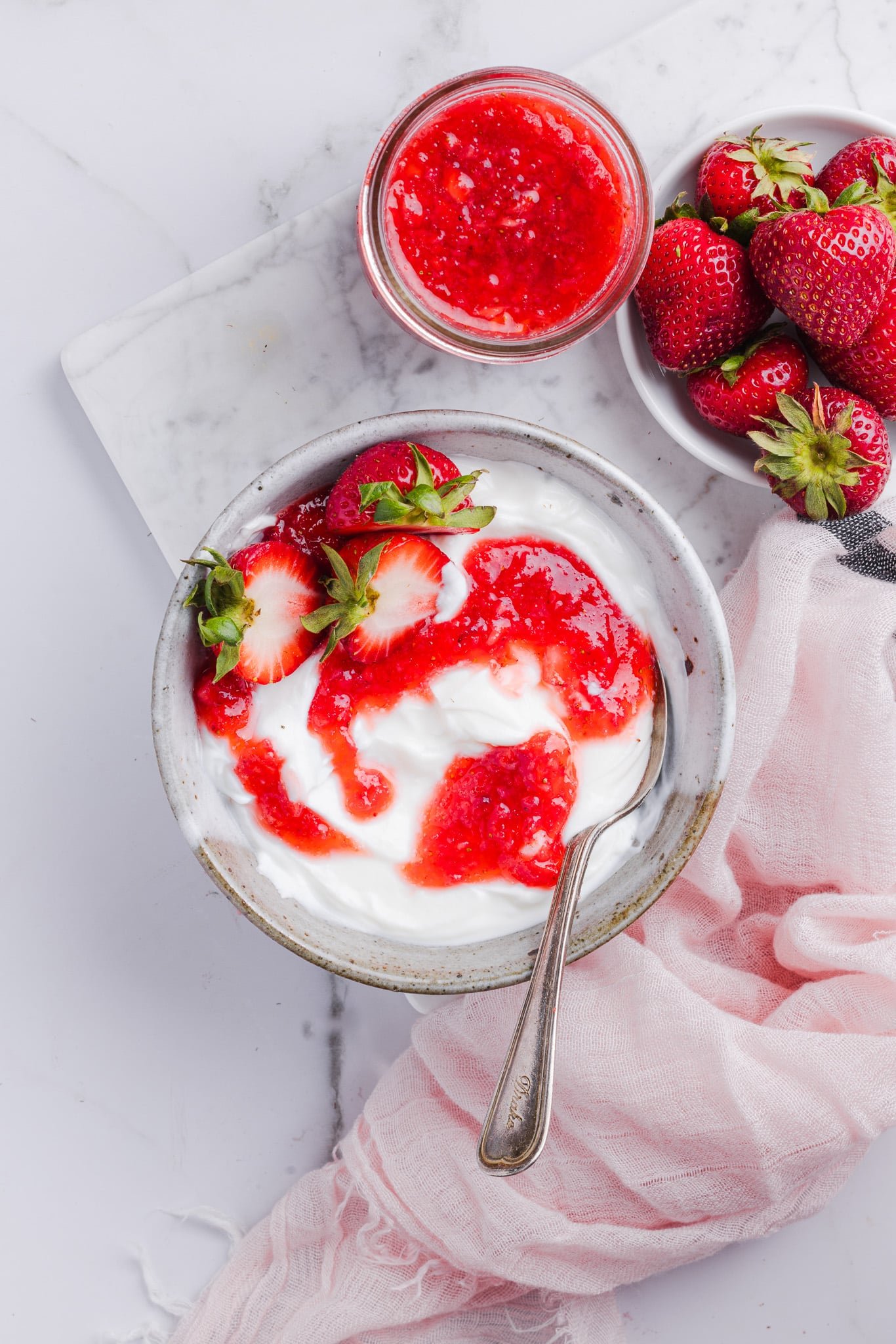 Low sugar strawberry freezer jam swirled into yogurt.