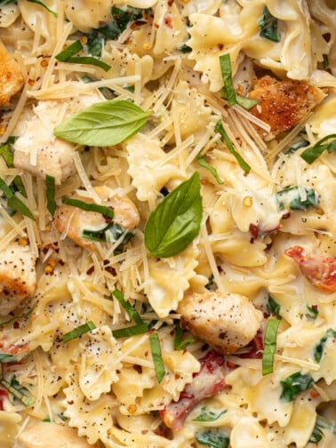 Marry me chicken pasta in a pan garnished with basil.