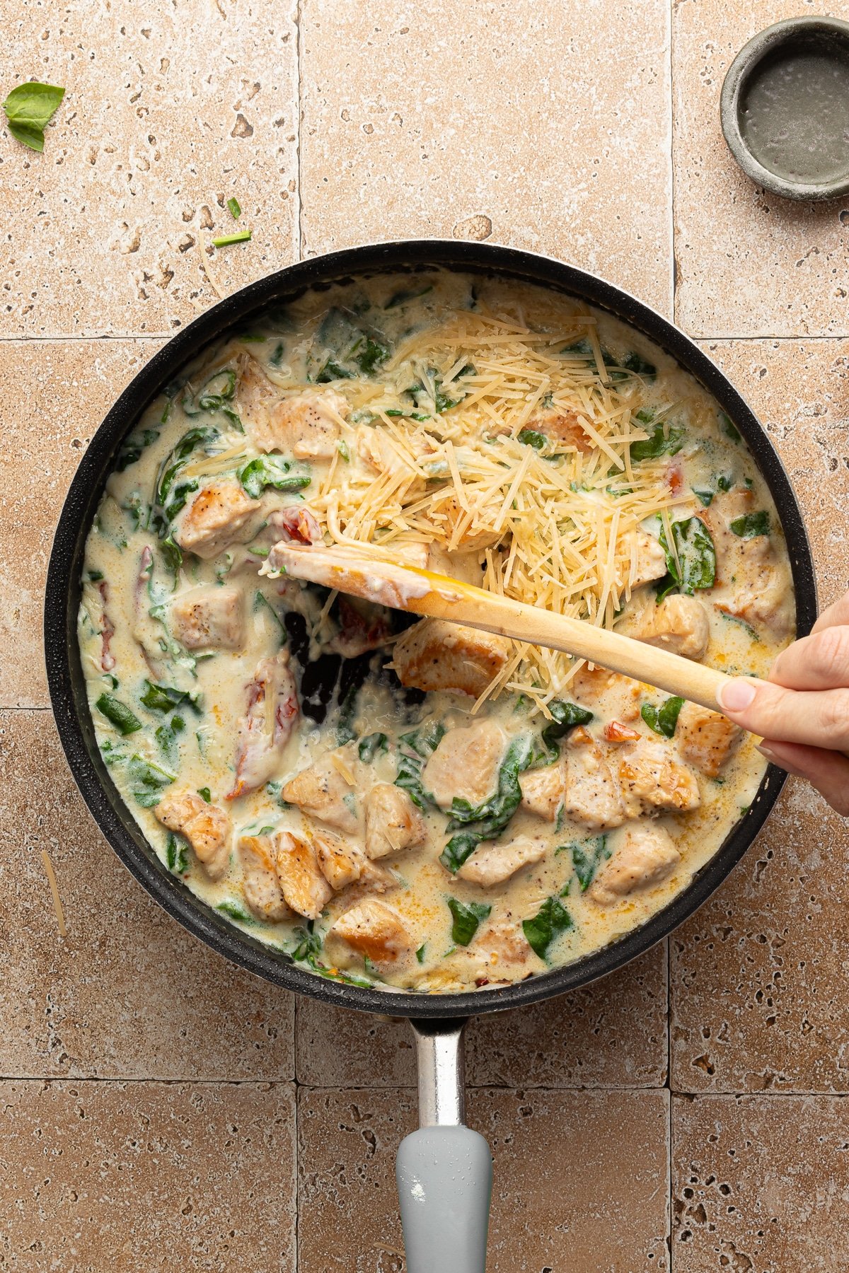 Marry me chicken pasta simmering in a pan.