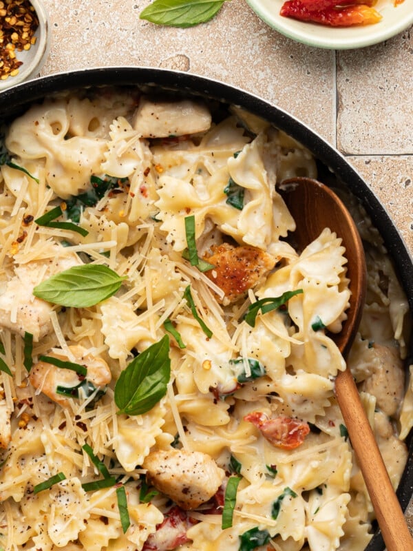 Marry me chicken pasta in a pan garnished with basil.