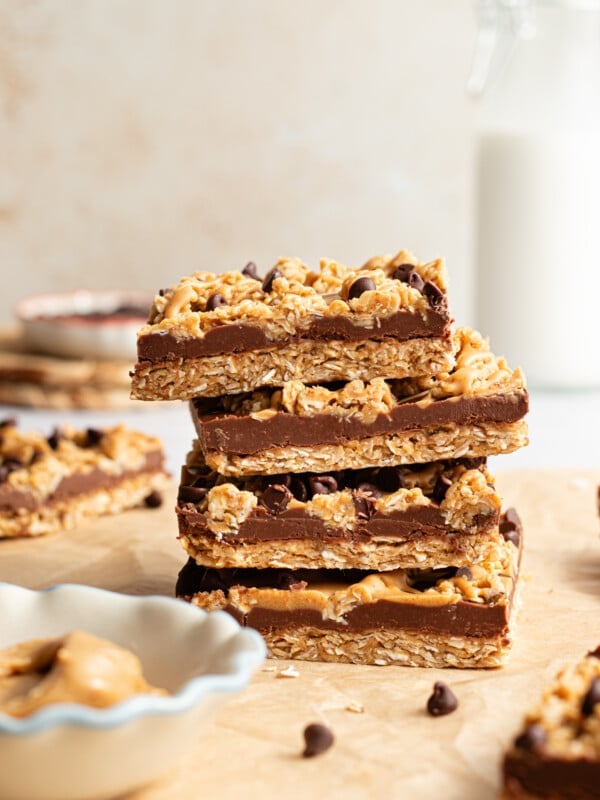 No bake chocolate oat bars stacked on top of one another.