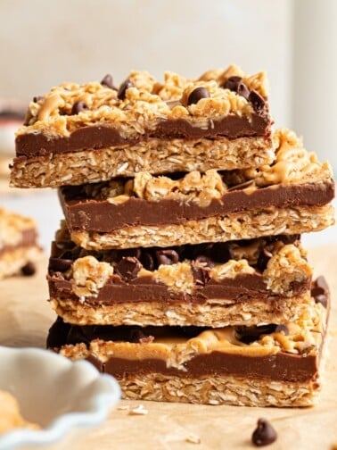 No bake chocolate oat bars stacked on top of one another.