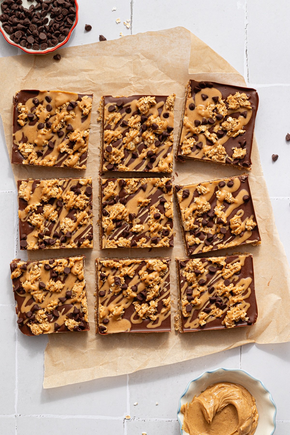 No bake chocolate oat bars sliced on parchment paper.