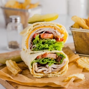 A cottage cheese wrap filled with turkey, cheese, bacon, lettuce and tomato.