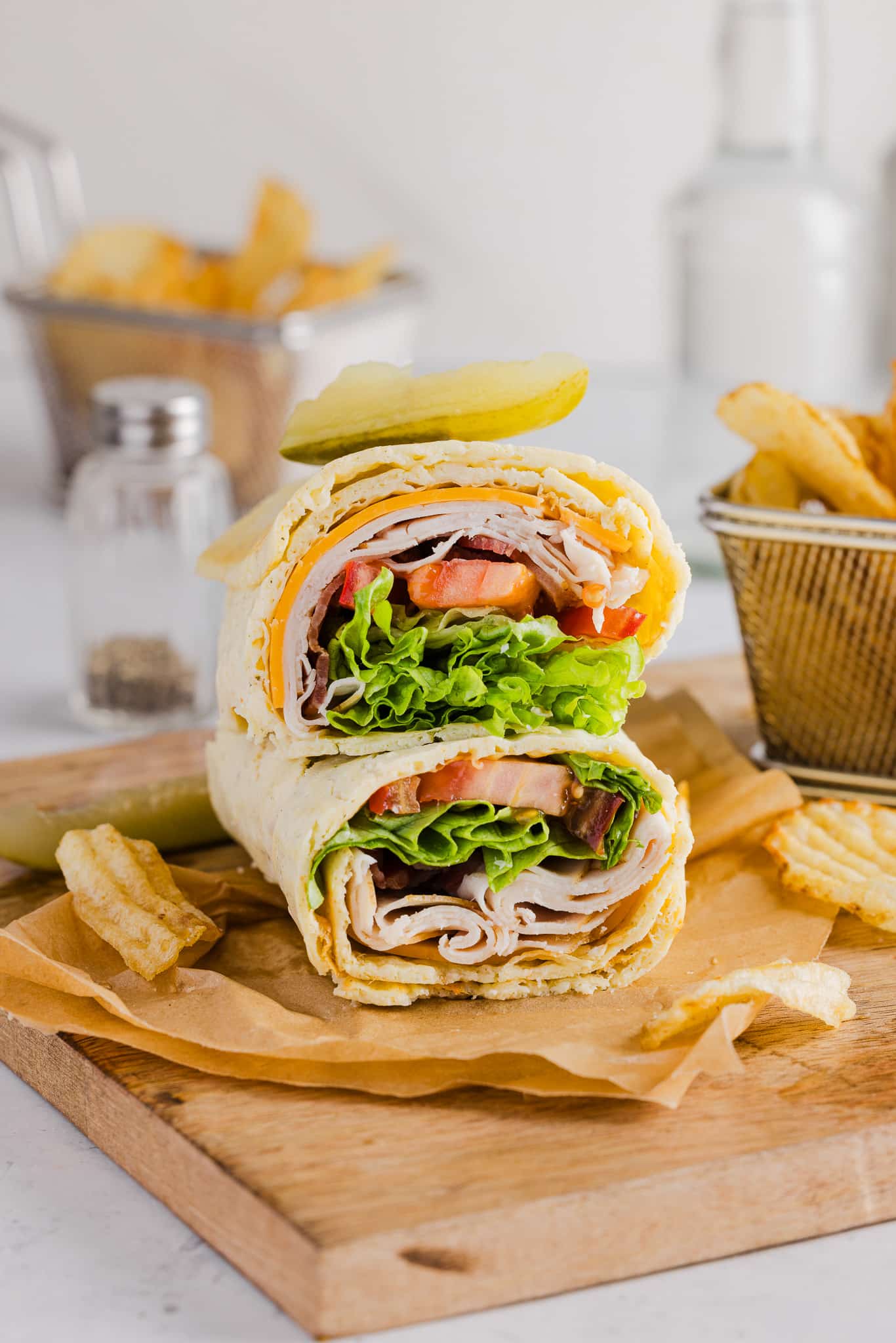 A cottage cheese wrap filled with turkey, cheese, bacon, lettuce and tomato.