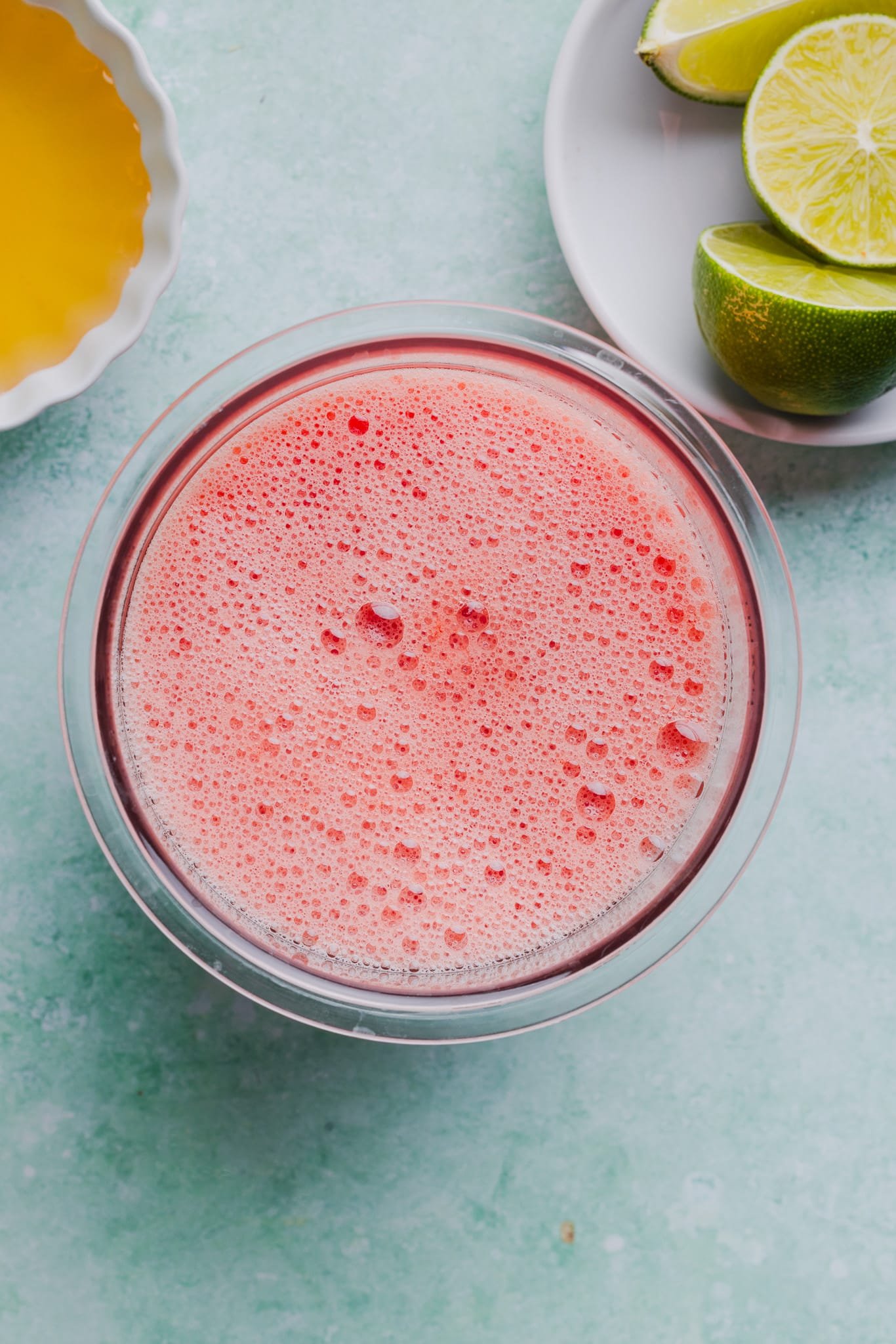 Blended watermelon, lime, and honey in a Ninja Creami pint container.
