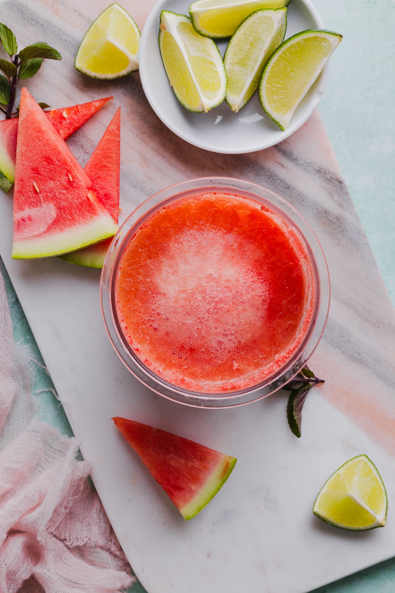 Blended watermelon, lime, and honey frozen in a Ninja Creami pint container.