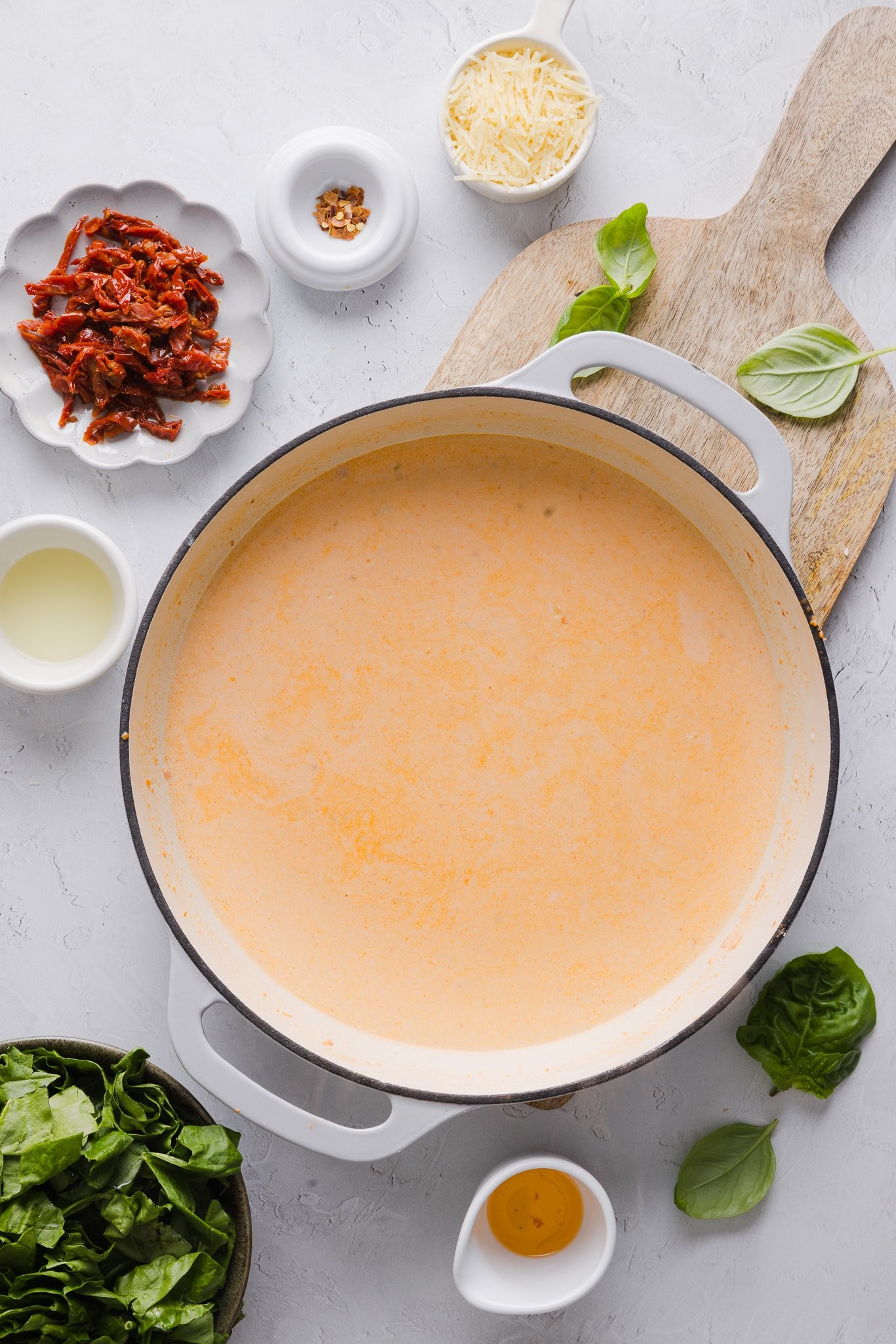 Creamy sauce in a pan for marry me chicken meatballs.