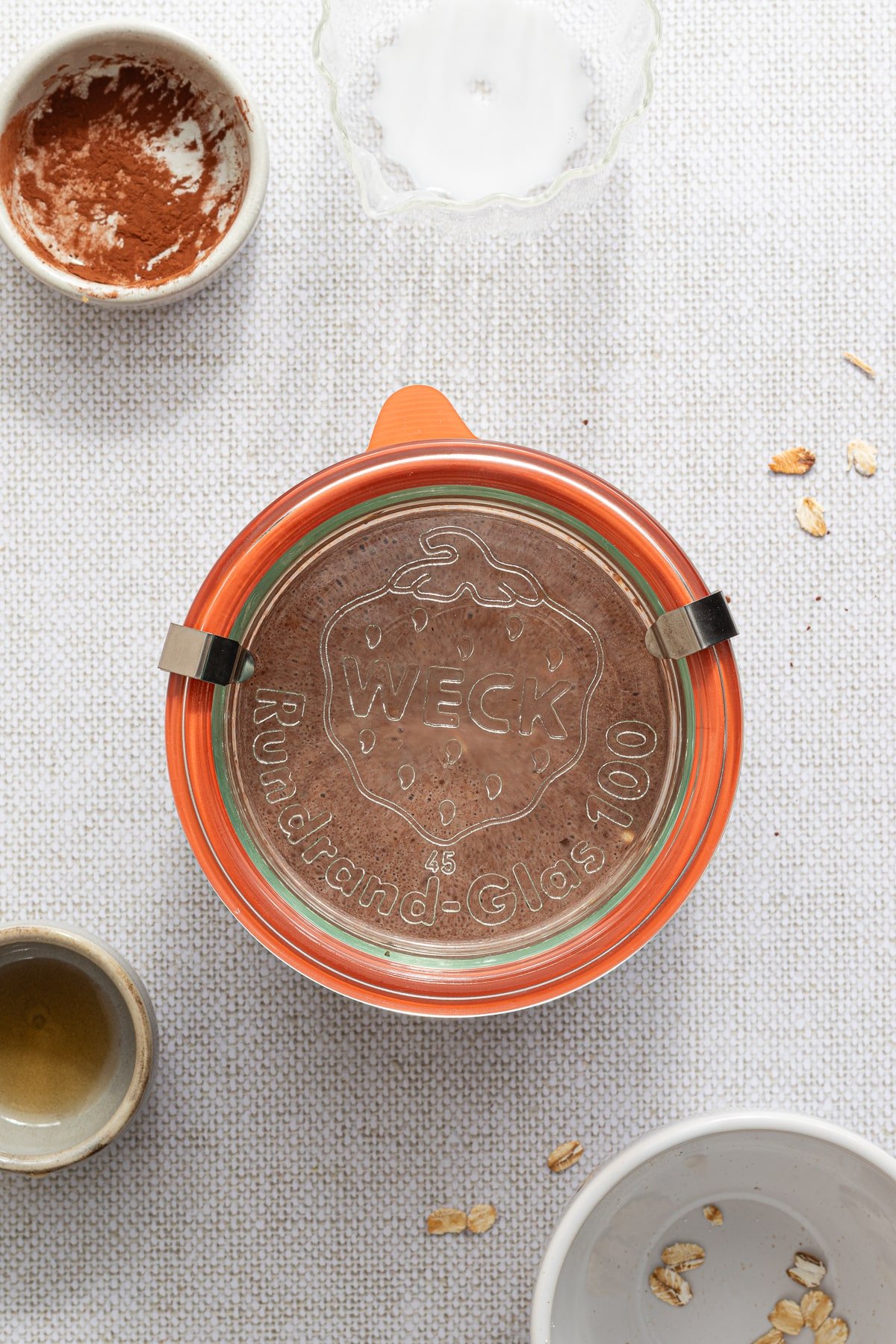 Sealing a jar full of chocolate peanut butter overnight oats.