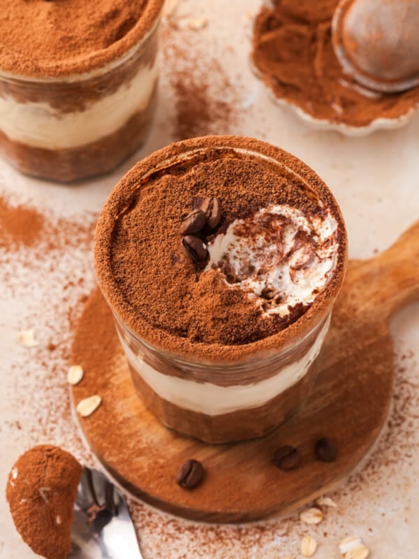 A jar of tiramisu overnight oats with a bite taken out of it.