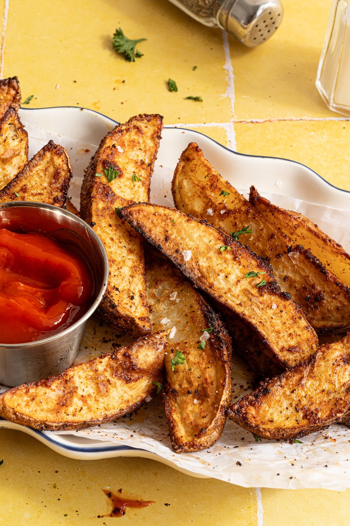 Crispy air fryer potato wedges with ketchup.